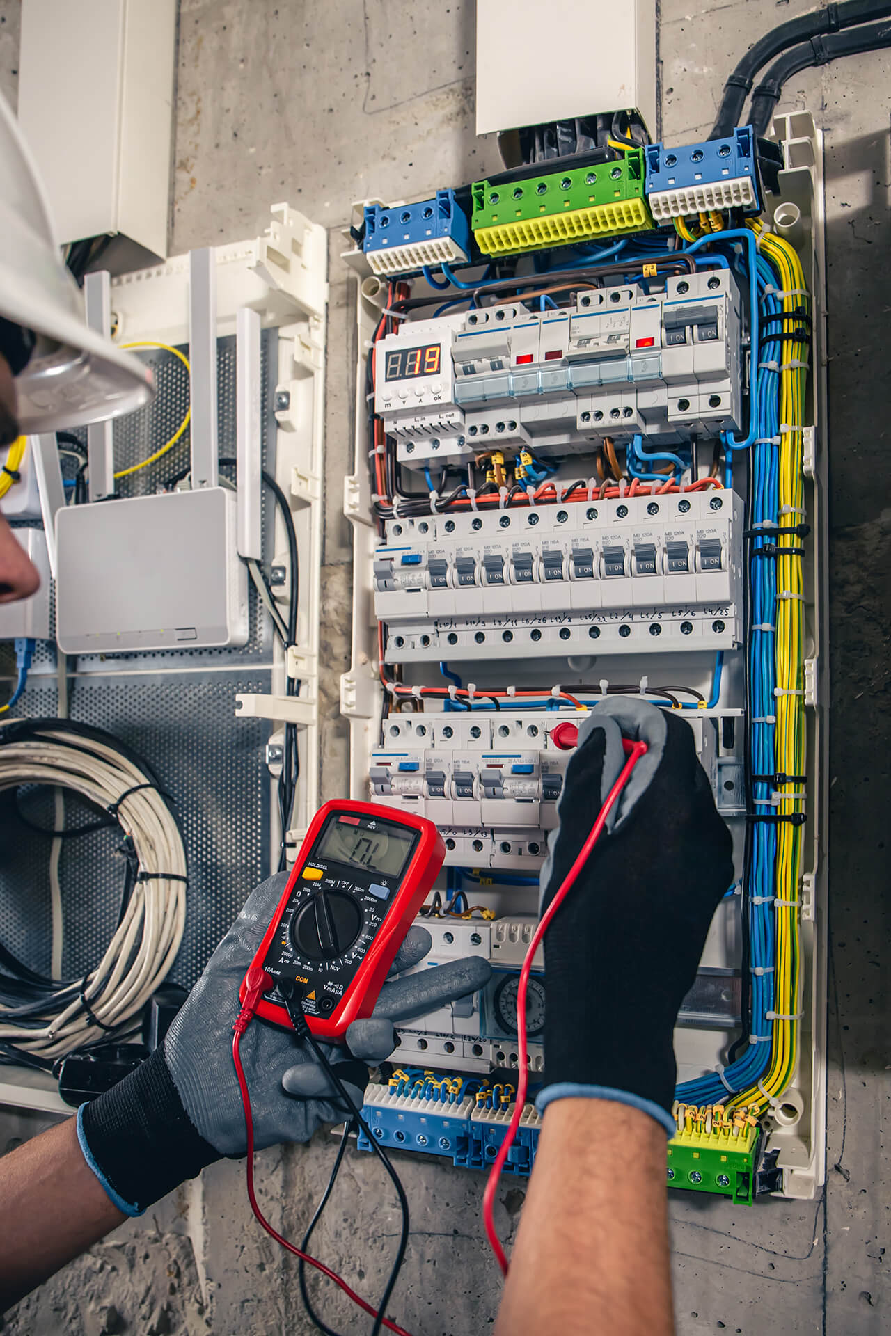 Electrical technician working switchboard with fuses